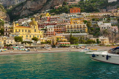 Sea by houses on mountain