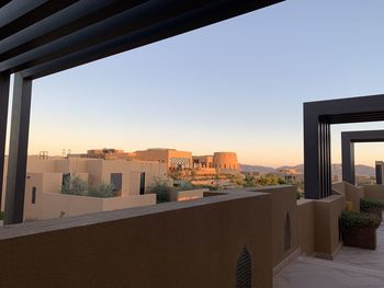 Buildings against clear sky during sunset