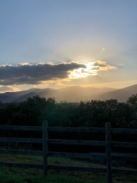 Scenic view of field against sky during sunset