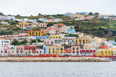 The port of the ponza island in summer. coloured houses, boats, ferry in the harbour. ponza italy