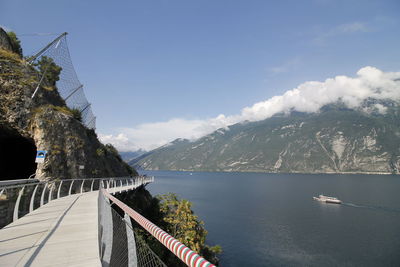 Scenic view of river by mountains against sky