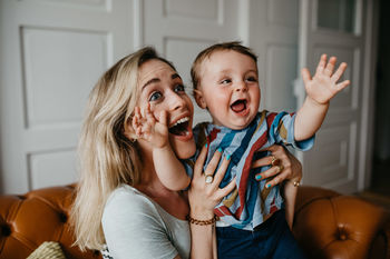 Cheerful mother with son at home