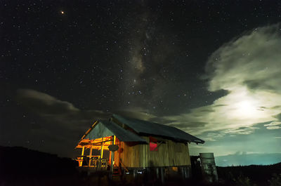 Low angle view of illuminated house against sky at night