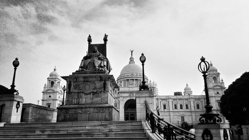 Low angle view of statue in front of victoria memorial against sky