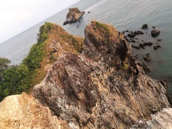 High angle view of rocks on shore against sky