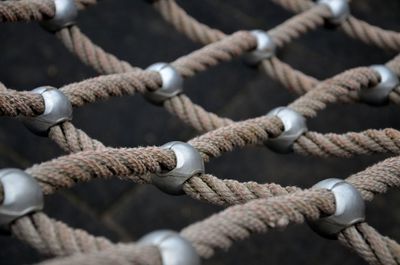 Close-up of rope tied up on metal