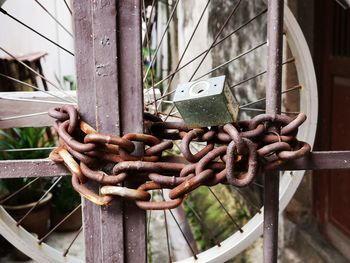 Close-up of rusty metal chain on gate