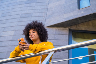 Young woman looking away while using mobile phone