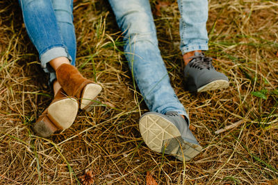 Low section of woman wearing shoes on ground