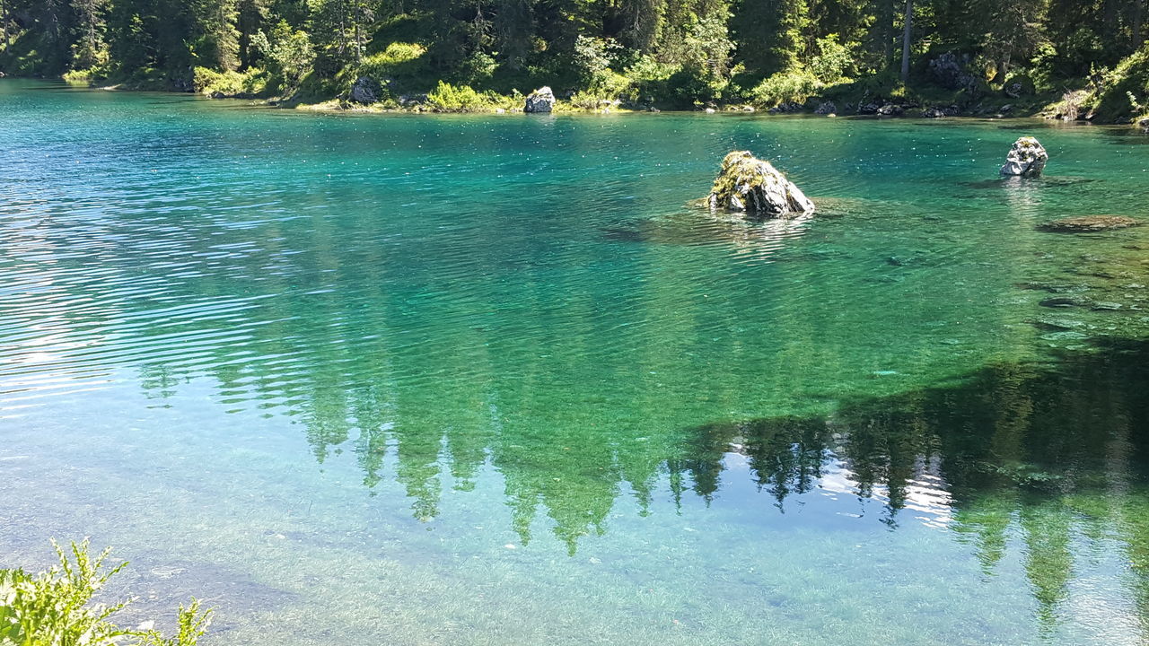 REFLECTION OF PEOPLE IN LAKE