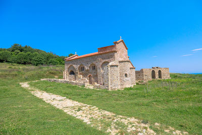 Old ruins against clear blue sky