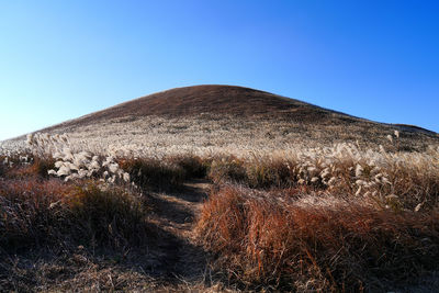 Scenic view of mountains against clear blue sky