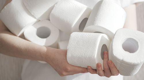 Midsection of person holding white flowers