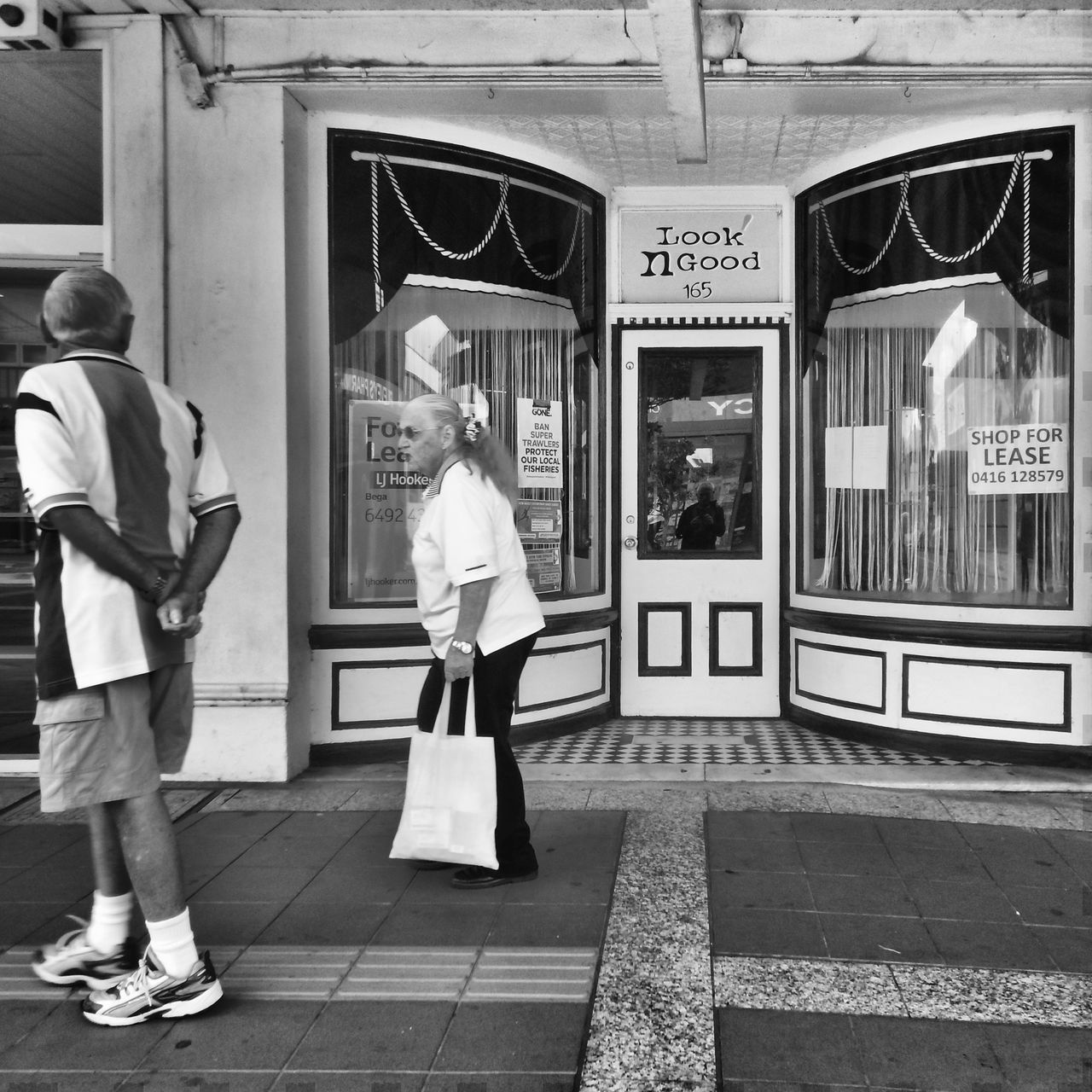 WOMAN STANDING ON CITY STREET