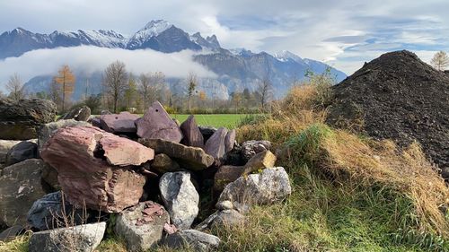 Stack of rocks on mountain against sky