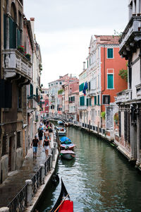 Boats in canal with buildings in background