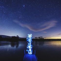 Scenic view of lake against star field at night