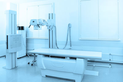 X-ray department in modern hospital. radiology room with scan machine with empty bed. 