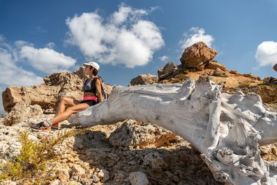 Full length of woman on rock against sky