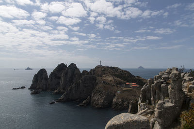 Rock formations in sea against sky