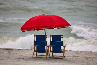 Chair on shore at beach