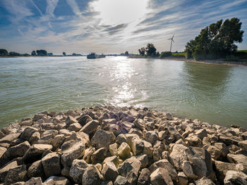 Scenic view of sea against sky with rocks in foreground