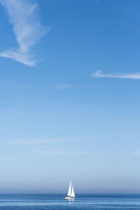 Sailboat in sea against sky