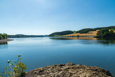 Scenic view of lake against blue sky