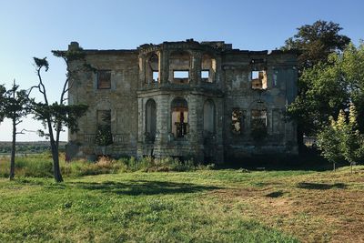 Low angle view of abandoned building against clear sky