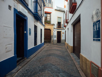 Empty alley amidst buildings in city