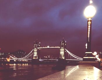 Illuminated bridge at night