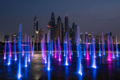 Panoramic view of illuminated buildings against sky at night