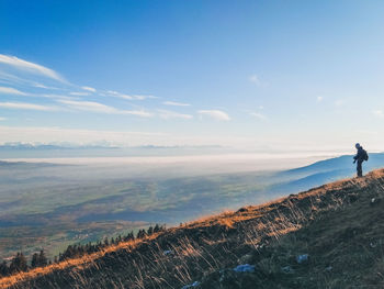 Man standing on land against sky