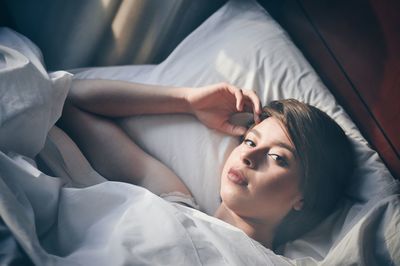 Woman lying on bed