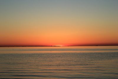 Scenic view of sea against romantic sky at sunset