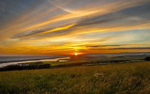 Scenic view of sunset over land