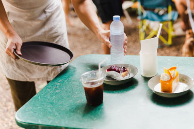 Midsection of man preparing food on table