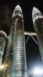 Low angle view of skyscrapers lit up at night