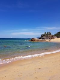 Scenic view of beach against blue sky