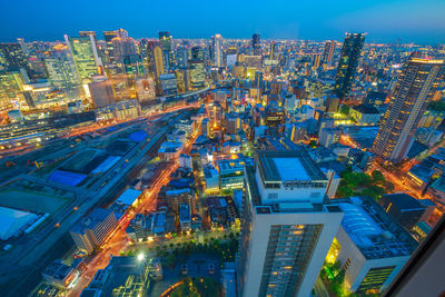 High angle view of illuminated buildings in city at night