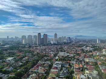 Aerial view of modern buildings in city against sky