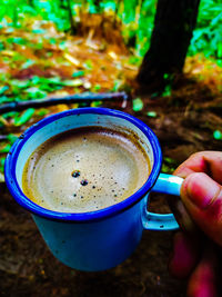 Close-up of hand holding coffee cup