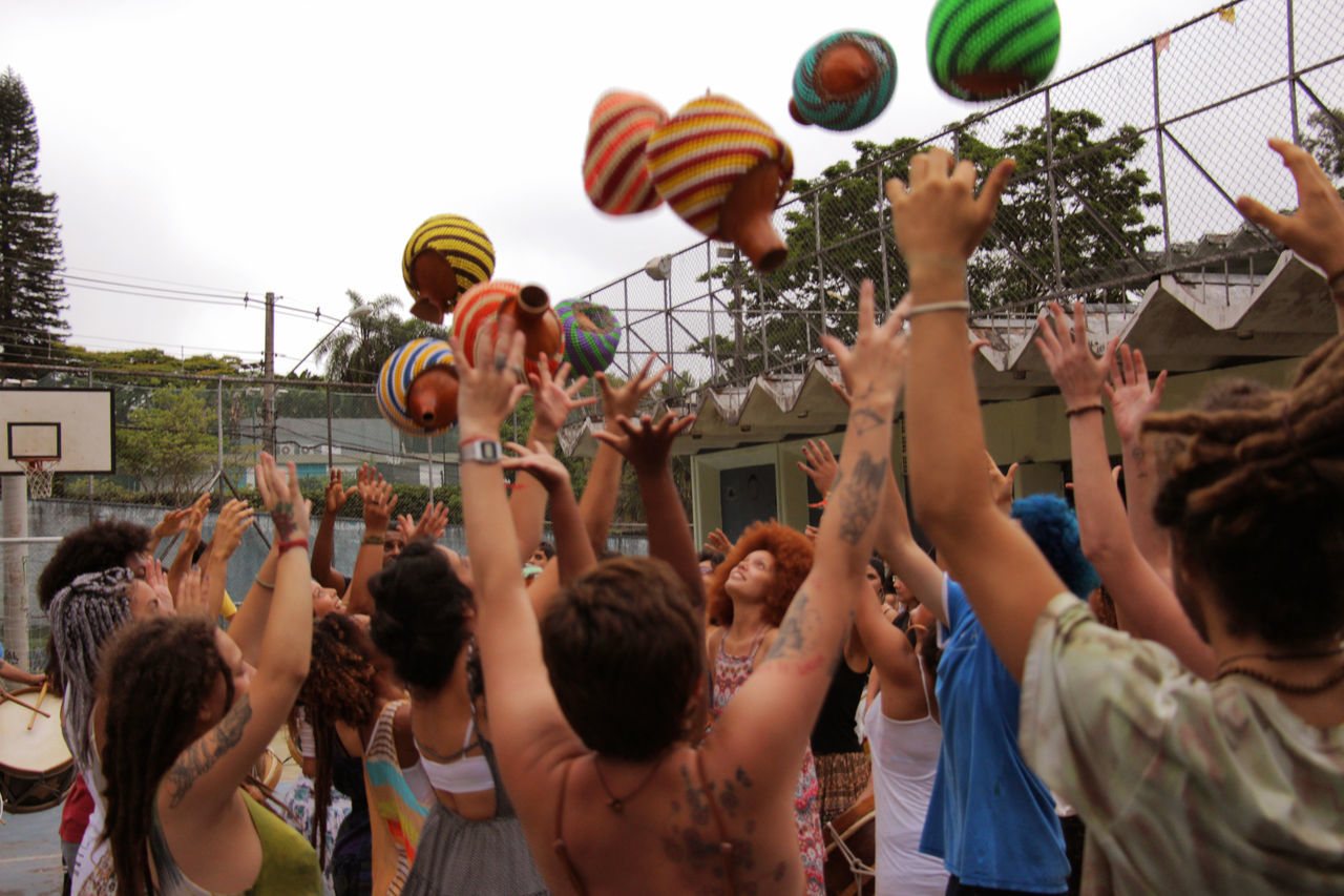 GROUP OF PEOPLE PLAYING BASKETBALL IN COURT