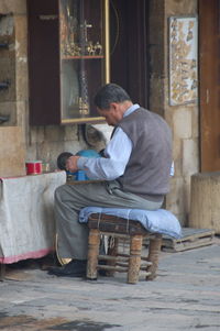 Father with baby sitting in a room