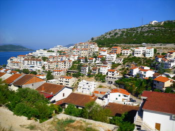 Buildings in city against clear sky