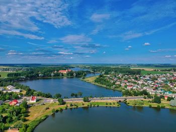 High angle view of river amidst cityscape against sky