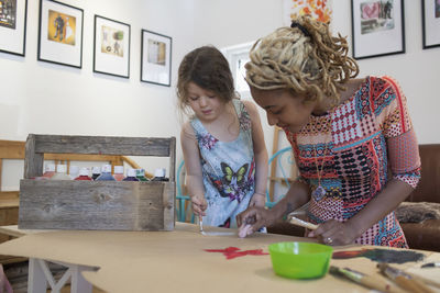 Girl and woman on table