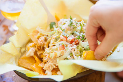 Close-up of person holding food in plate