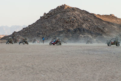 Panoramic view of people on mountain road against sky