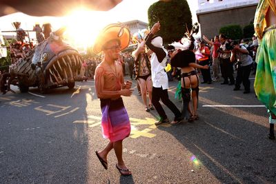 Rear view of woman standing on city street